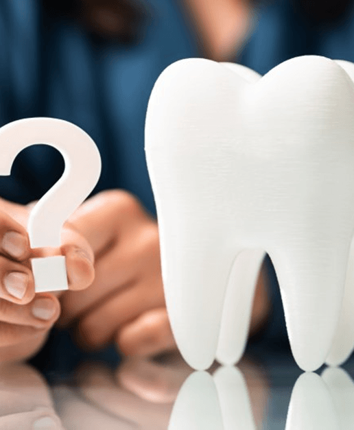 a person holding a question mark next to a tooth