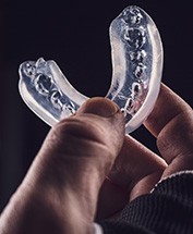 Hand holding clear mouthguard