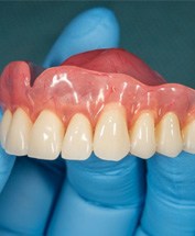 a person holding a set of dentures