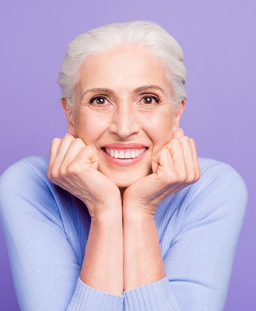 a patient with dental implants smiling 