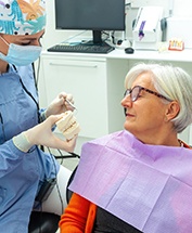 a patient during her dental implant consultation 
