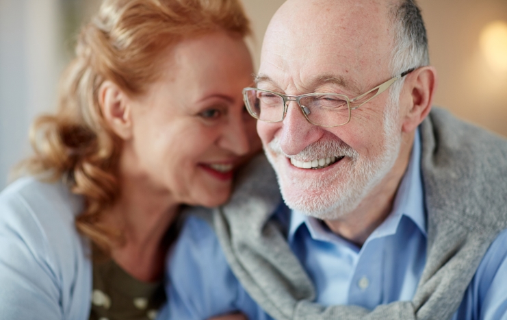 Man and woman with healthy smiles after restorative dentistry