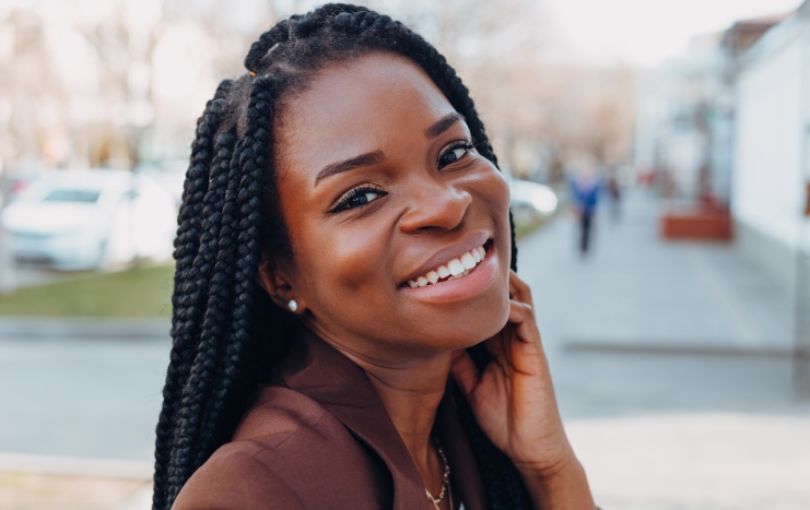 Woman sharing healthy smile after emergency dentistry