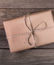 Package tied with string on wooden table