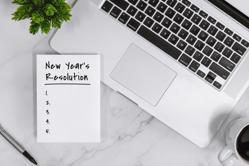 New Year’s Resolution list on notebook with laptop