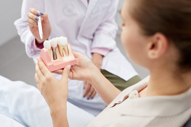 Woman visiting the dentist for a dental implant consultation.