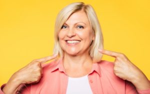 mature woman smiling with dental implants