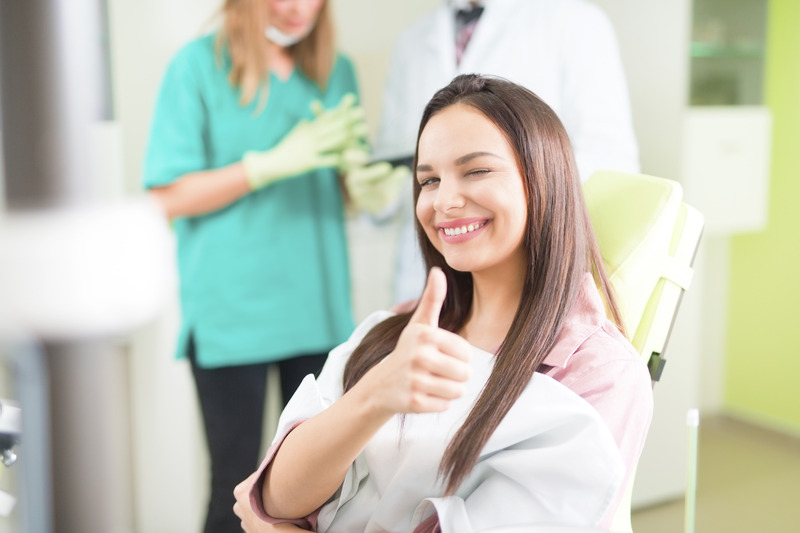 Patient smiling in dental chair during dental checkup