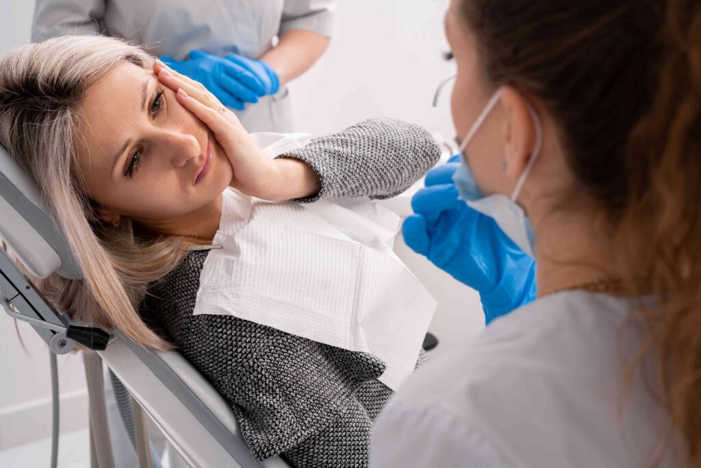 Woman with tooth pain at the dentist